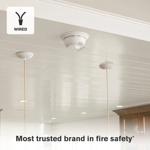 Close-up of a hardwire smoke detector installed on a ceiling with a wired connection, part of a 12 Pack Hardwire Interconnect Smoke Detectors With Battery Backup For Reliable Whole House Sync And Smart Thermal Readings That Ditch Annoying False Alerts From Kitchen Fry Ups While Keeping Your Crew Totally Safe Inside.