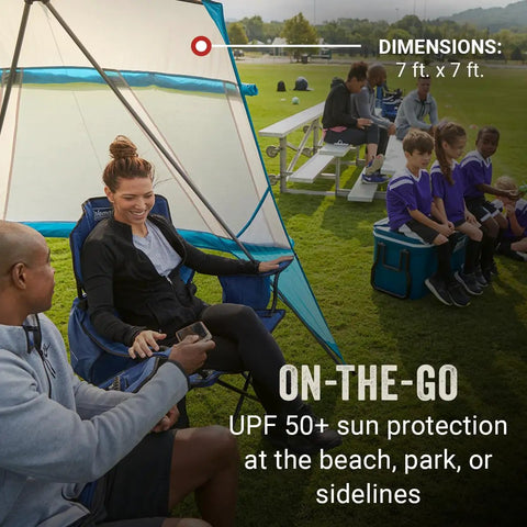Portable 7x7ft Backpack Sun Shelter with Lightweight Shade Canopy set up at a park, adjustable side walls, people seated inside