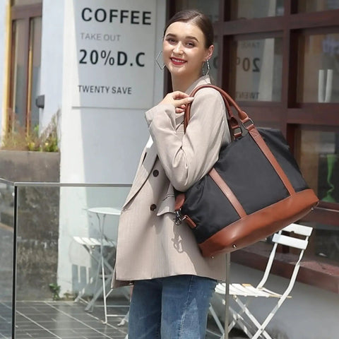 Woman carrying Weekender Travel Bag For Women, Canvas Duffel Tote with Water Resistant Oxford Fabric