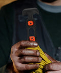 Close-up of a person holding a Beefy Rubber Flexible T Handle Hasp Draw Latch for car hood, toolbox, and truck doors
