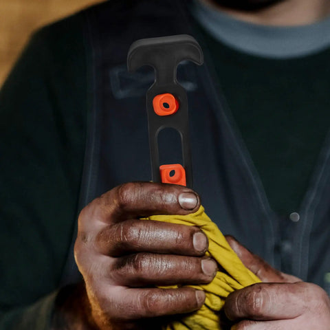 Close-up of a person holding a Beefy Rubber Flexible T Handle Hasp Draw Latch for car hood, toolbox, and truck doors