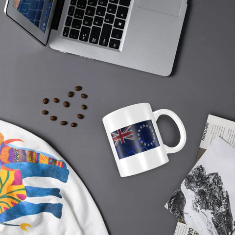 Flag Of The Cook Islands Mug 11 Oz Ceramic Coffee Cup With Handle Double Sided Print Awesome Gift For Home Office Desk And Everyday Coffee Tea Lovers Everywhere on a desk near a laptop and coffee beans.