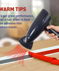 Using hair dryer to warm adhesive film before installing Garage Door Seal Kit Top and Sides Weather Stripping 34.4 Ft Rubber