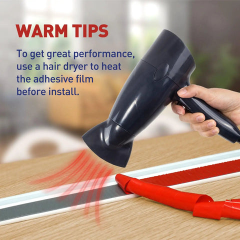 Using hair dryer to warm adhesive film before installing Garage Door Seal Kit Top and Sides Weather Stripping 34.4 Ft Rubber