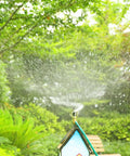Heavy Duty 360 Degree Rotating Rooftop Sprinkler For Backyard Boss Lawn Cooling And Garden Watering With Smooth Sweep Adjustment And Built Different Zinc Frame spraying water in a lush garden.