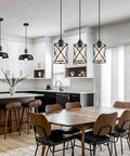 Fresh Matte Black Three Light Pendant With Clear Glass Shades Adjustable Farmhouse Industrial Hanging Fixture over a dining table.