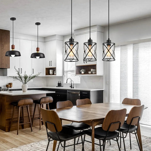 Fresh Matte Black Three Light Pendant With Clear Glass Shades Adjustable Farmhouse Industrial Hanging Fixture over a dining table.