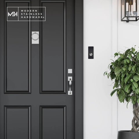 Sick Modern Stainless Doorbell Black R7 Series With Anodized Aluminum Button next to a black door in a stylish entryway.