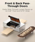 55W Desktop CO2 Laser Engraver For Wood Acrylic Leather Cutting And Etching With Quick Auto Focus And Blazing Speed showing front and back pass-through doors with a skateboard.