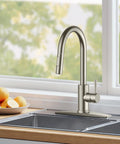 Badass Brushed Nickel Kitchen Faucet With Pull Down Sprayer And Dual Spray Patterns High Arc Gooseneck Design in sink with fresh fruit.