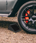 Heavy Duty Rubber Wheel Chocks Set Of 4 For Cars Trailers Trucks And RC Vehicles Grippy Non Slip Tire Stoppers Stabilizer Wedges With Crack Resistant Construction 4.72 Inches By 3.93 Inches By 5.90 Inches placed under car tire