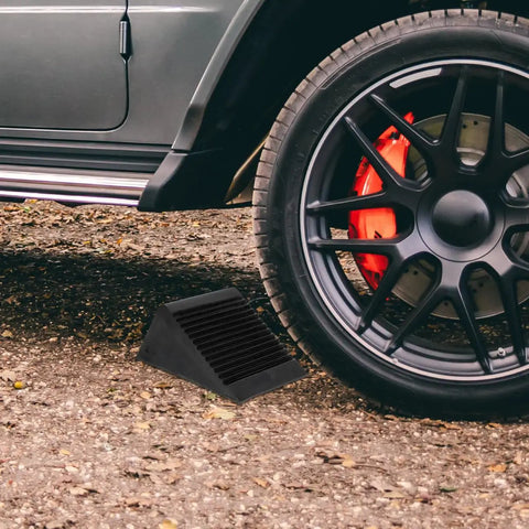 Heavy Duty Rubber Wheel Chocks Set Of 4 For Cars Trailers Trucks And RC Vehicles Grippy Non Slip Tire Stoppers Stabilizer Wedges With Crack Resistant Construction 4.72 Inches By 3.93 Inches By 5.90 Inches placed under car tire