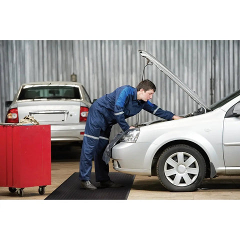 Mechanic using Air Step Anti Fatigue Floor Mat Black 36 Inch Long 24 Inch Wide With Three Eighths Inch Vinyl Foam Cushioned Support