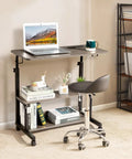 Unwind And Handle Daily Grind At This Grey Oak Rolling Standing Desk With Height Adjustable Top Smooth Gliding Wheels Grab And Go Mobility Side Hooks And Roomy Storage Shelves For Your Home Office Setup with laptop on the surface.