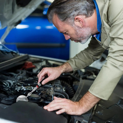 Mechanic using Six Piece Telescoping Inspection Mirrors Set With 360 Degree Rotation to inspect engine under vehicle hood