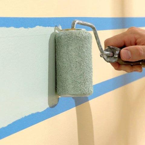 Painter using roller over blue 0.7 Inch Painter's Tape 3 Pack With 54 Yards Each For Sharp Lines And Easy Removal, creating sharp lines.