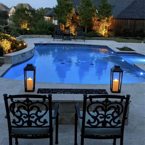 Large Outdoor Solar Powered Lantern With Open Frame No Glass Black Metal 19 Inch Tall Dusk To Dawn Timer Flickering LED Candle Lantern For Porch Patio Garden Rustic Farmhouse Vibe by a poolside at dusk