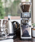 Top Tier Conical Burr Coffee Grinder With Smart Dosing Controls and Customizable Grind Settings on kitchen countertop.