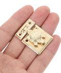 Hand holding Two-Pack Heavy Duty Jewelry Box Latch With Decorative Turtle Lock Buckle, iron hardware shown closely.
