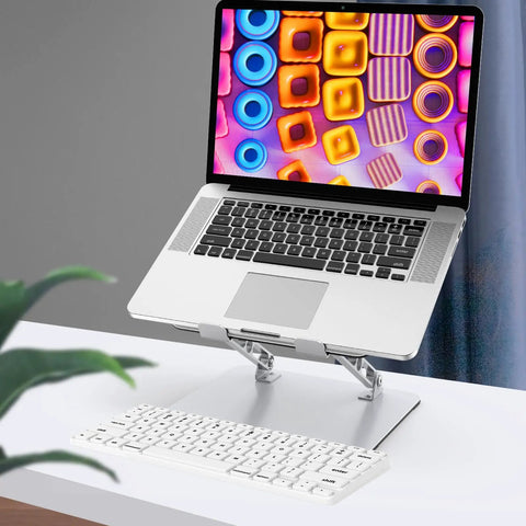 Adjustable Laptop Stand For Desk With Ergonomic Design, Ventilated Cooling, And Foldable Metal Riser holding a 15-inch laptop