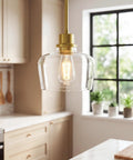 Emak 8 Inch Pendant Lights Kitchen Island, 1-Light Brushed Gold Kitchen Pendant Lights with Clear Glass Shade, hanging lamp close-up.