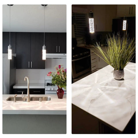 Slick Modern Pendant Light With LED Bubble Crystal Shades for Kitchen Island in chrome above a marble countertop with flowers.