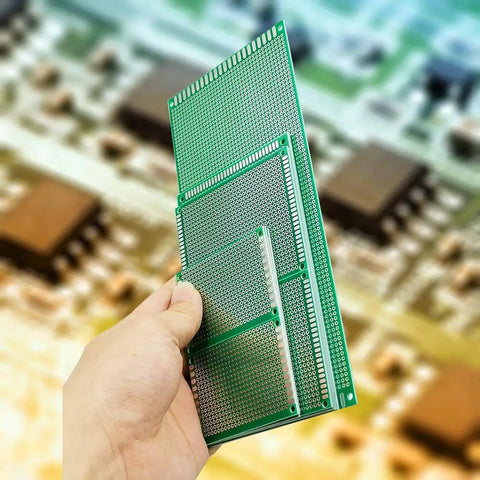 Hand holding 11 Piece Large PCB Board Kit In 4 Sizes 10X22 Cm, 15X9 Cm, 9X7 Cm And 7X5 Cm Blank Prototype Boards for Soldering Projects