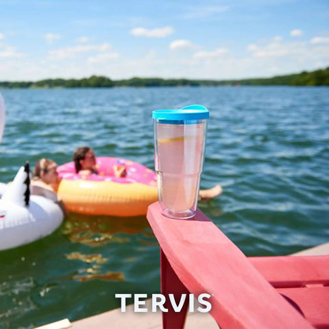 Washington Commanders 24oz Double Wall Insulated Tumbler Cup next to lake with people on inflatables
