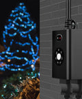 Weatherproof Outdoor Sensor Timer With Dual Grounded Outlets Delivers Zero Fuss Dusk To Dawn Light Control And Seven Quick Countdown Modes For Flawless Yard And Party Decor mounted on a wall next to lit blue Christmas tree.