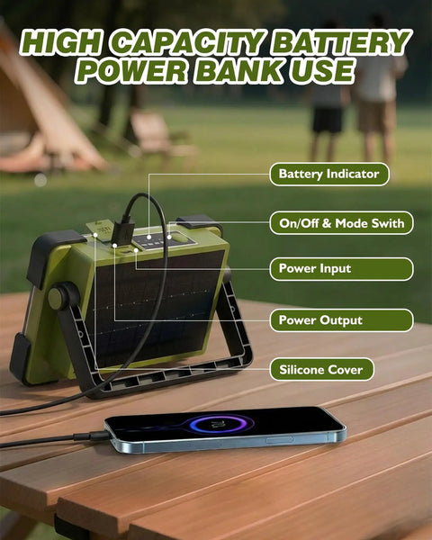 Go-To Solar Rechargeable Work Light With Stand, 120W Flood Light, on picnic table charging a phone, solar panel visible