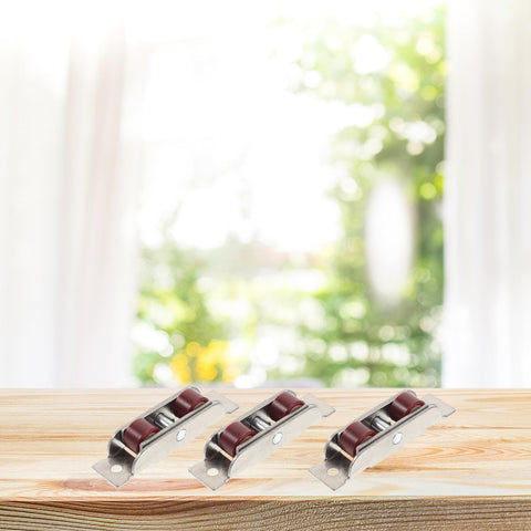 Top Shelf Stainless Steel Sash Wheels For Silky Smooth Sliding Windows And Patio Doors Heavy Duty Double Roller Pulleys set of four on wooden surface.
