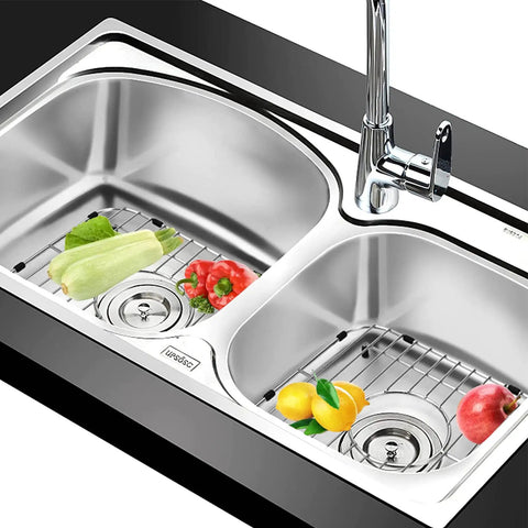 Double Bowl Kitchen Sink Protector Grid 304 Stainless Steel Universal Kitchen Sink Grid Bottom Rack Guard Keeps Your Sink Scratch Free Centered Drain 13.2 x 11.6 x 1.25 Inches Rubber Feet 2 Pack in use with vegetables and fruits.