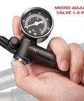 Hand holding High Pressure Bike Shock Pump 300 PSI With Gauge For Mountain Bike Front Fork And Rear Suspension No Loss Air Pump Easy Setup For Smooth Rides Black Finish, showing micro adjust valve.