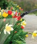 1-Gallon Handheld Farm and Garden Sprayer With Easy Fill Funnel Top And Large Secondary Opening spraying flowers in garden