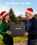 Two people exchanging gift box outdoors during Christmas