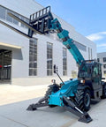 Heavy Duty Telescopic Forklift With Fast Swap Quick Hitch Setup For Effortless Pallet Handling On Rough Ground parked outside a building.