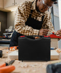 Badass Low Profile Plastic Toolbox With Tight Fitting Lid And Ergonomic Handle For All Your Bolts and Art Pieces on a workbench.