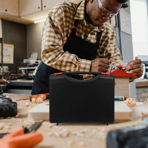 Slick Small Portable Plastic Toolbox With Lid And Ergonomic Handle, Light As A Feather Tool Box For Crafts And Yard Work, Tough As Nails Shock Resistant Case that is black with a grip on a workbench.