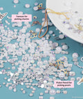 Nail Art Glitter Kit Multicolor 3D Charms For DIY Nails, showing pearls, butterfly charms, with tweezer and picker pencil on blue surface.