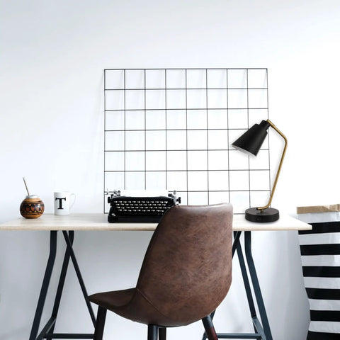 Industrial Luxe 17 Inch Desk Lamp in Matte Black with Antique Brass accents on home office desk with typewriter.
