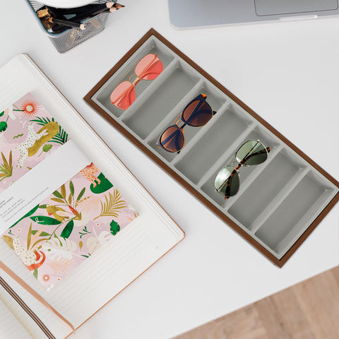 Slick Wooden Sunglasses Display Tray With Soft Gray Velvet Lining Seven Grid Eyewear Organizing Rack with sunglasses on a desk.