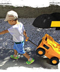 Side view of yellow PUQU monster-truck travel suitcase on wheels being pulled by a child