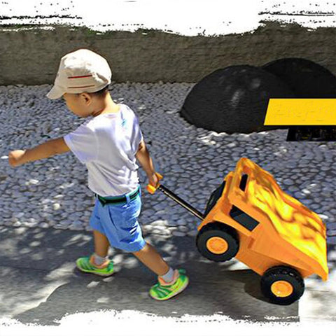 Side view of yellow PUQU monster-truck travel suitcase on wheels being pulled by a child
