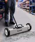 18 Inch Magnetic Sweeper With 26 Lbs Pull Rolling Wheels And Telescoping Extension Handle For Quick Debris Release Heavy Duty Metal Pickup Tool To Grab Nails Screws Washers On Carpets And Floors in use on warehouse floor