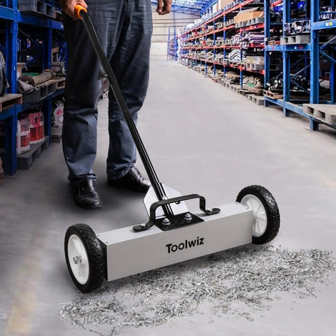 18 Inch Magnetic Sweeper With 26 Lbs Pull Rolling Wheels And Telescoping Extension Handle For Quick Debris Release Heavy Duty Metal Pickup Tool To Grab Nails Screws Washers On Carpets And Floors in use on warehouse floor