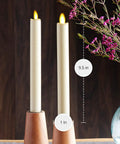 Flickering Flameless Ivory Taper Candles With Warm LED Flame Battery Operated 2 Pack in wooden holders on table