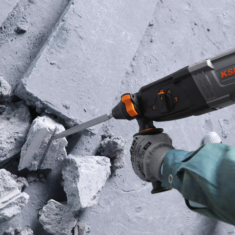 Heavy Duty 1 Inch Rotary Hammer Drill With SDS Plus 6.5 Amp Motor drilling concrete with visible debris on the ground