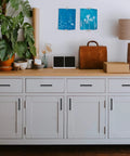 White cabinet with 30 Pack Solid 5 Inch Square Cabinet Handles Matte Black Pulls for kitchen cabinets and drawers installed.