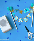 2.25 Inch Scalloped Circle Punch For Scrapbooks And Card Making, scissors, and craft decorations on blue background