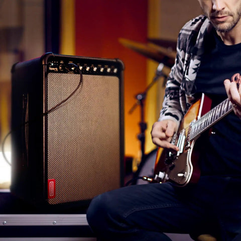 Musician using Spark Live Smart Guitar Amp With 4-Channel PA, Built-In Mixing, Effects, And App Control in studio setting